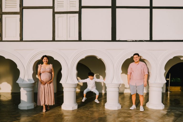 A group of people standing in front of a building Description automatically generated with low confidence