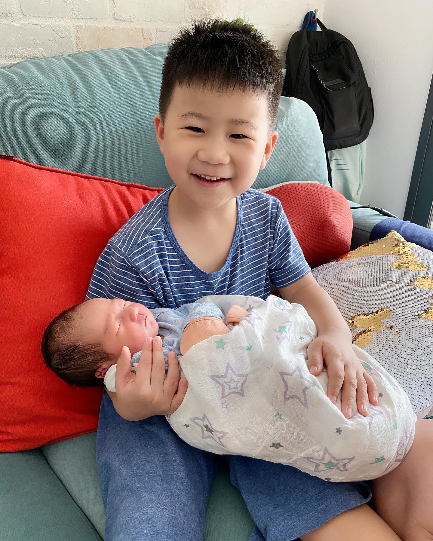 ways for dads to bond with newborn: Big brother hold his siblings. We've raising future husbands who wish to bond with their children in time to come