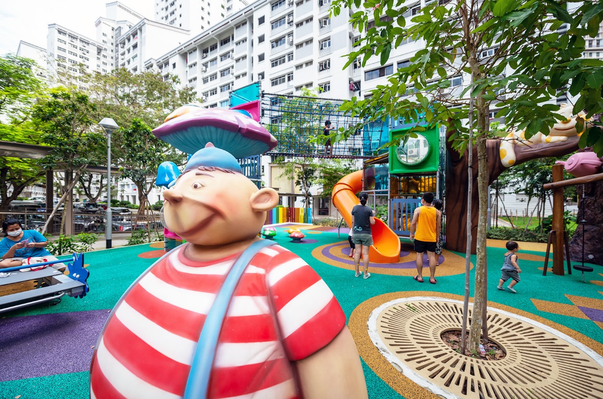 A large cartoon character in a playground

Description automatically generated