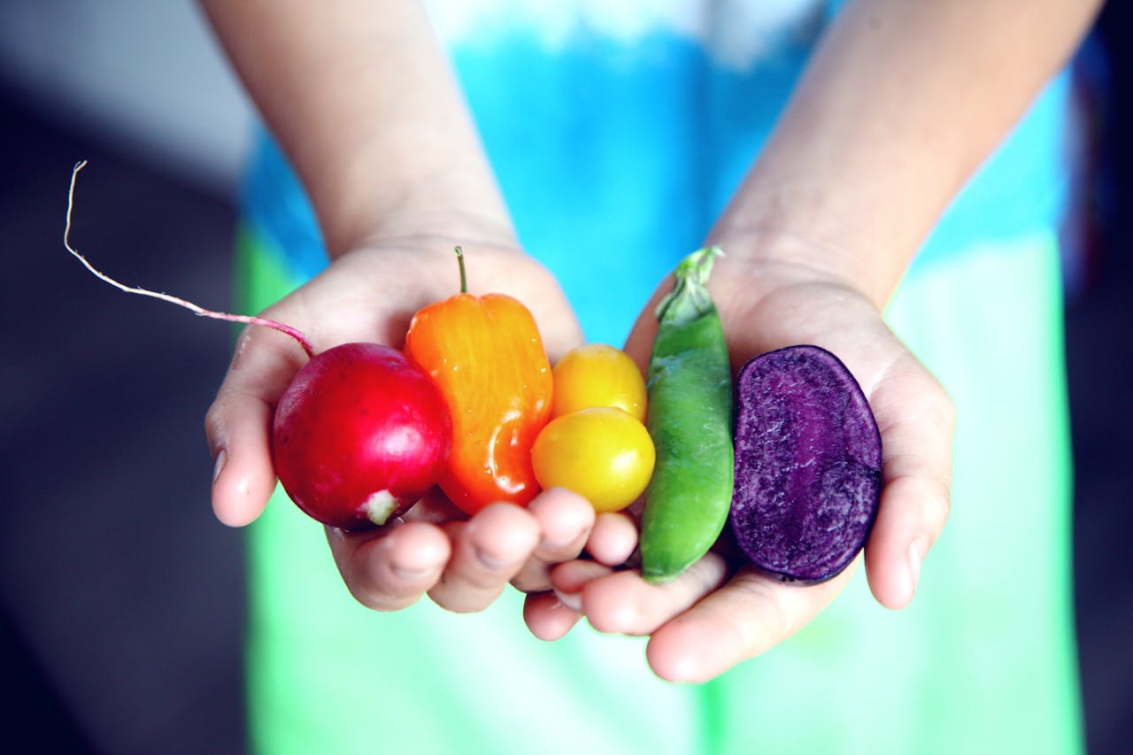 A person holding vegetables in their hands 