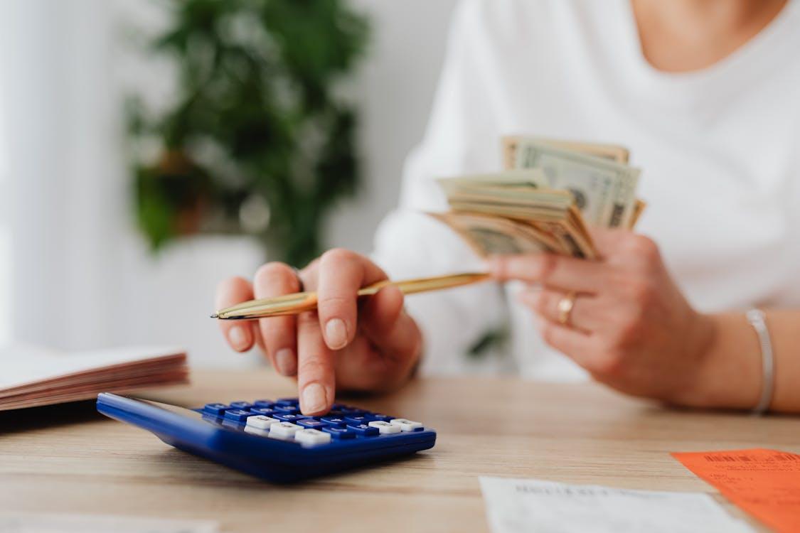 Free Person Using a Blue Calculator Stock Photo