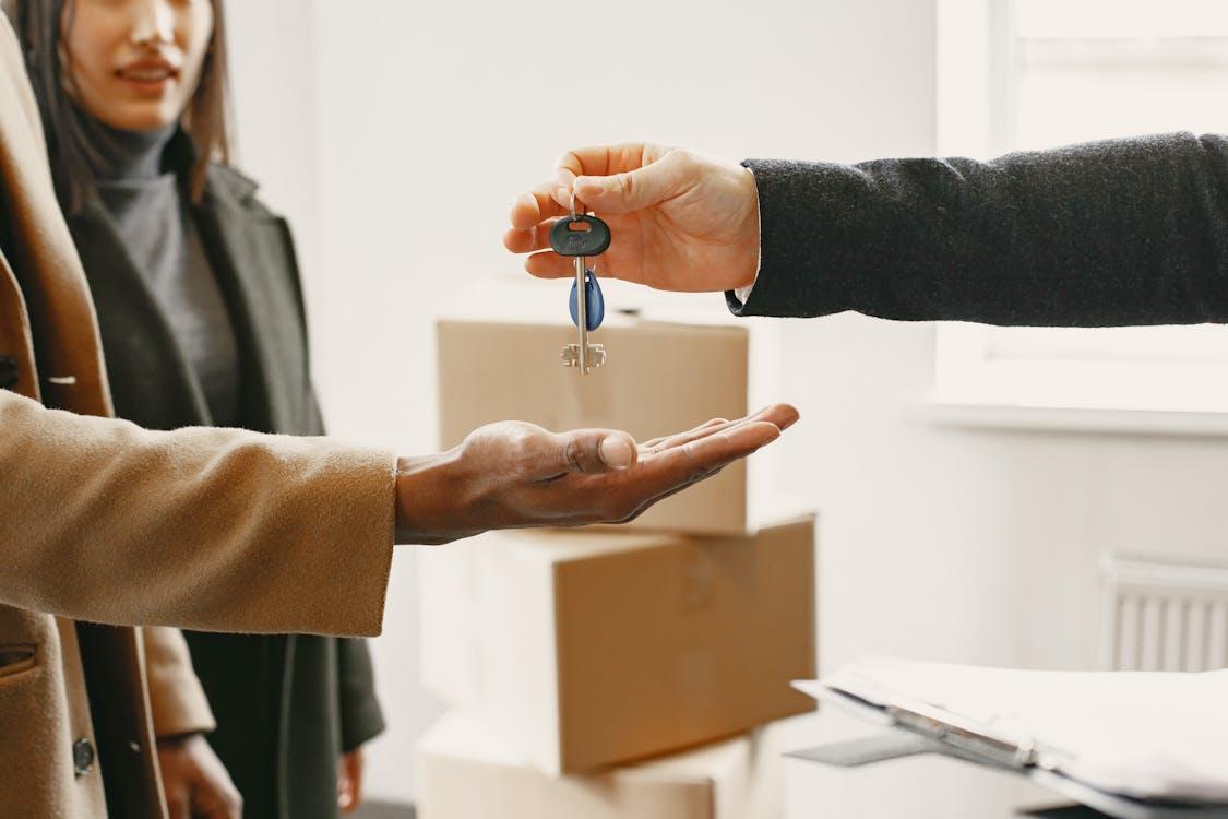 Free Person Giving Keys from New Home to Family Stock Photo